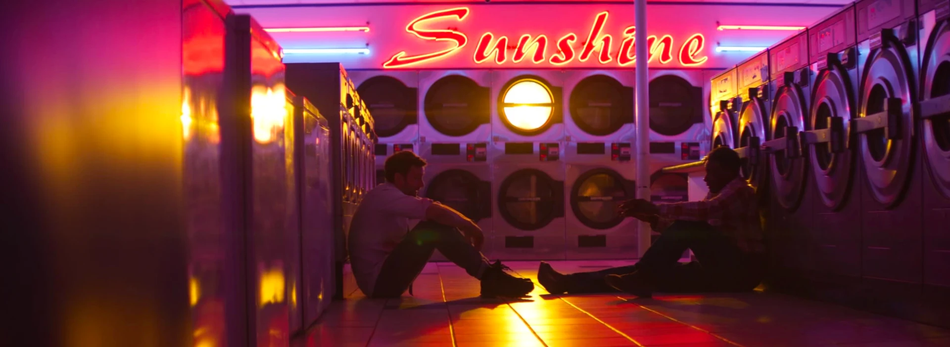Neon Sunshine laundromat at night